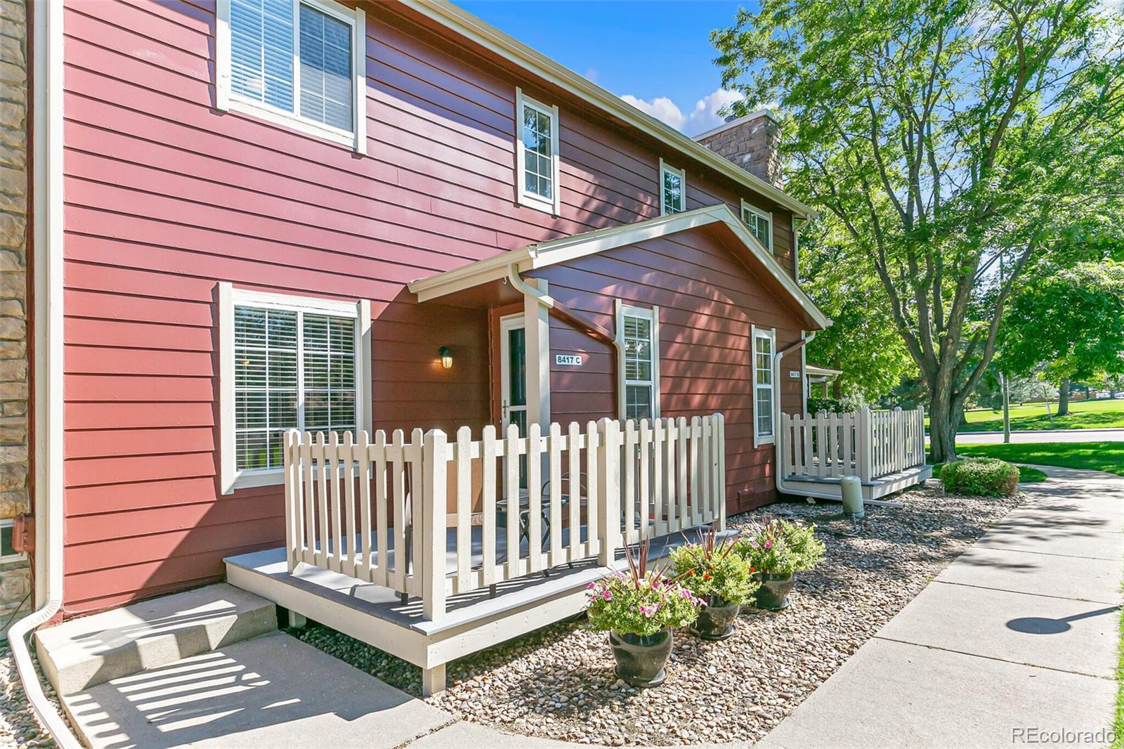 8417 Everett Way, Unit C Arvada, CO 80005 - Photo 1 of 34 a front view of a house with a garden