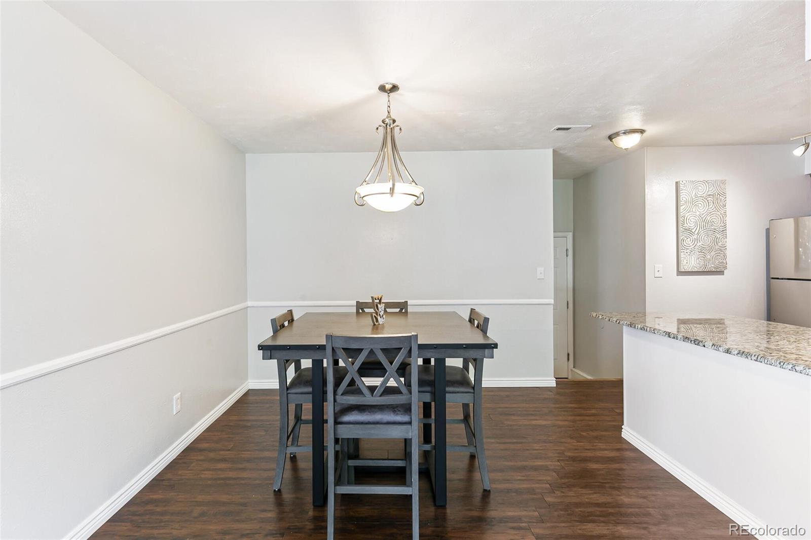 8417 Everett Way, Unit C Arvada, CO 80005 - Photo 13 of 34 a view of a dining room with furniture and wooden floor