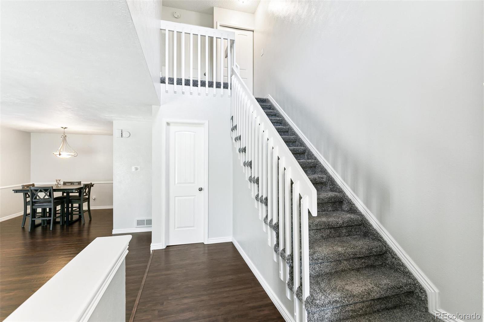 8417 Everett Way, Unit C Arvada, CO 80005 - Photo 22 of 34 a view of a hallway with wooden floor and staircase