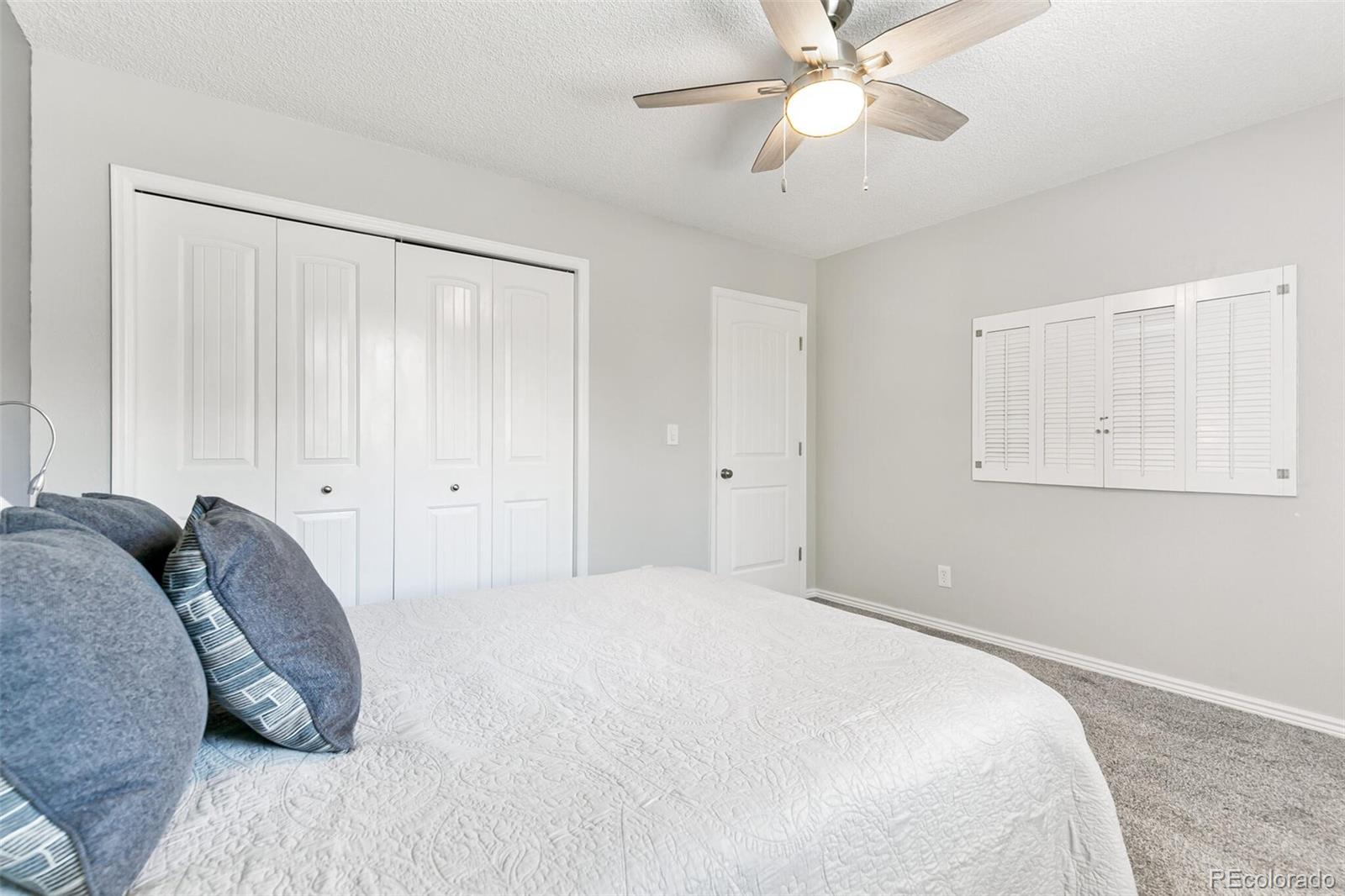 8417 Everett Way, Unit C Arvada, CO 80005 - Photo 24 of 34 a bedroom with a bed and a chandelier