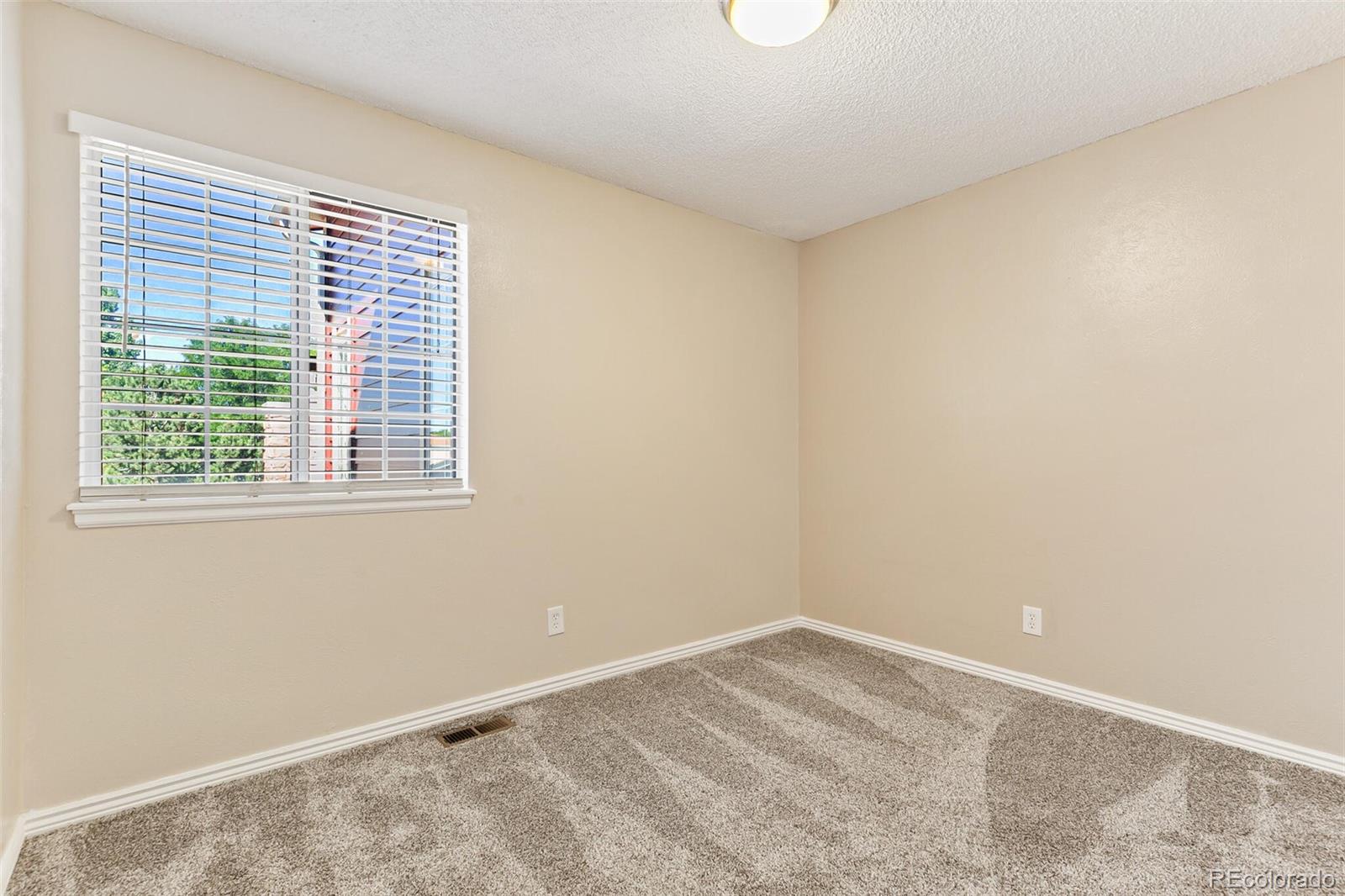 8417 Everett Way, Unit C Arvada, CO 80005 - Photo 25 of 34 a view of an empty room with a window
