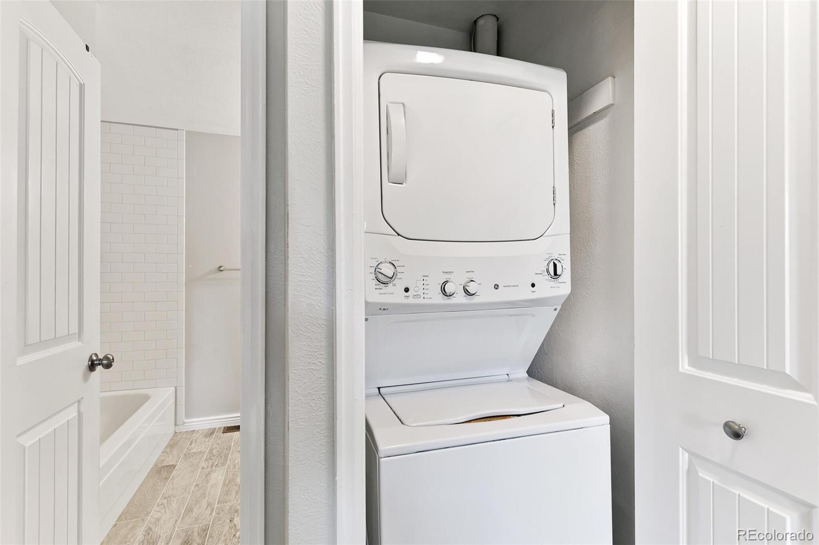 8417 Everett Way, Unit C Arvada, CO 80005 - Photo 28 of 34 a view of washer and dryer with bathroom in it