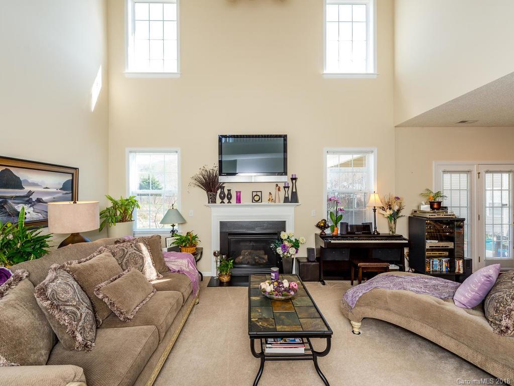 63 Woodfern Road Fletcher, NC 28732 - Photo 3 of 29 a living room with furniture a fireplace and a flat screen tv