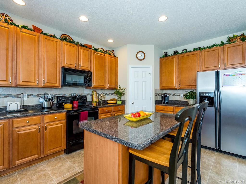 63 Woodfern Road Fletcher, NC 28732 - Photo 8 of 29 a kitchen with stainless steel appliances granite countertop a stove a sink a refrigerator and a microwave