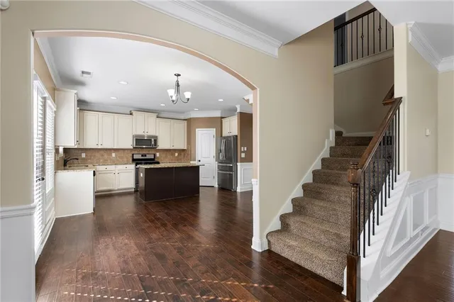 a view of kitchen with wooden floor and electronic appliances