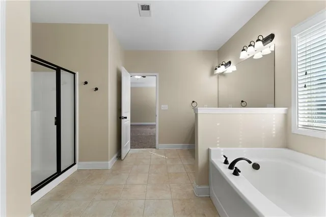 a bathroom with a bathtub and shower
