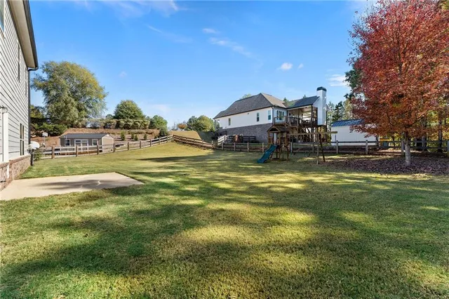 a view of a swimming pool with a house in the background