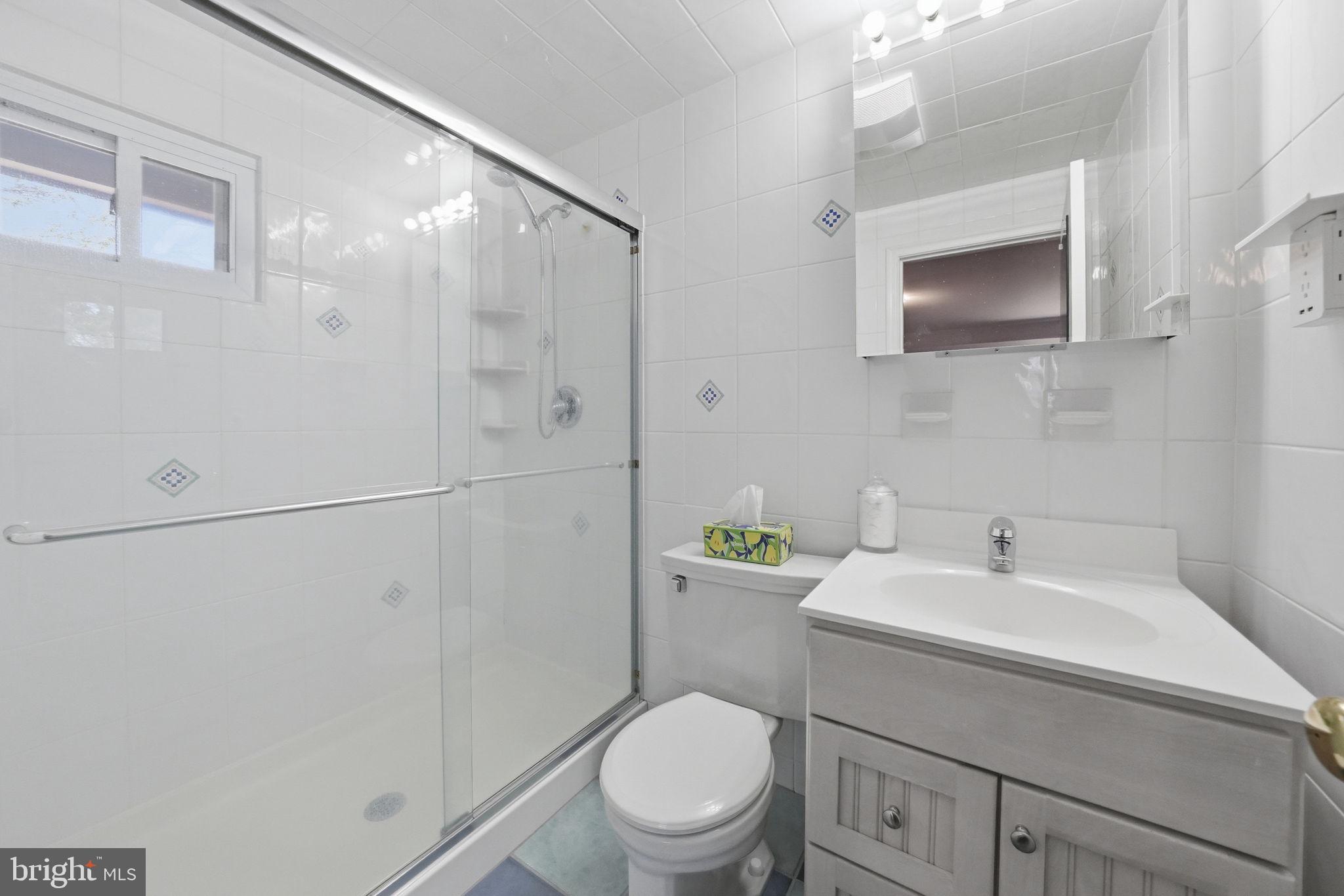 28 Green Ridge Road Yardley, PA 19067 - Photo 28 of 49 a bathroom with a toilet sink vanity and mirror