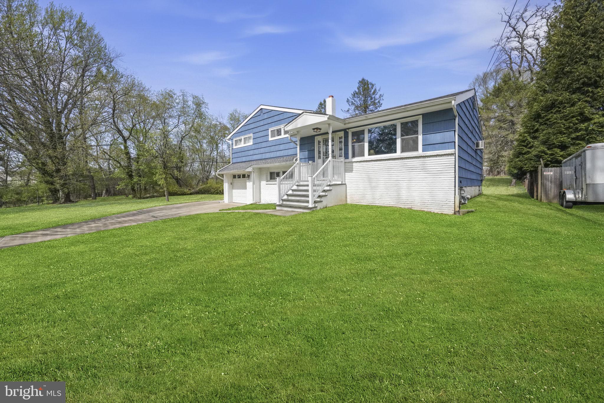 28 Green Ridge Road Yardley, PA 19067 - Photo 44 of 49 a white house with a big yard and large trees with wooden fence