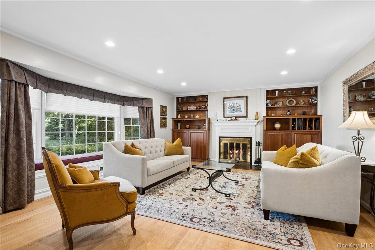 372 Fort Hill Road Scarsdale, NY 10583 - Photo 3 of 40 Living room featuring fireplace, built-ins and bay window with window seat