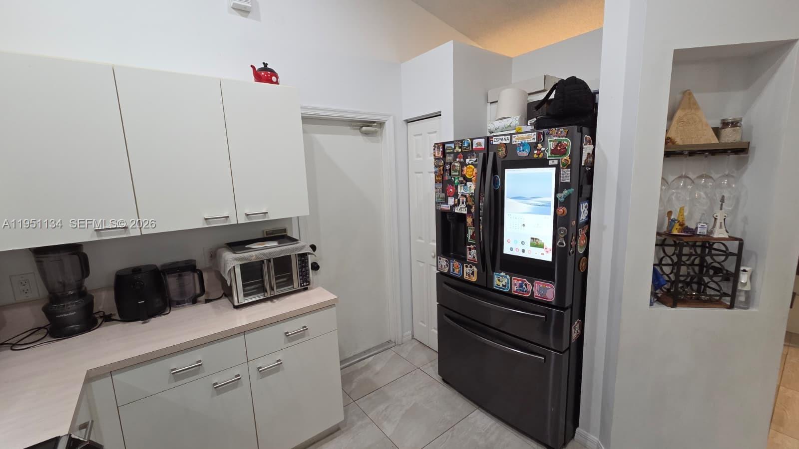 1308 Alexander Bend Weston, FL 33327 - Photo 15 of 54 a kitchen with stainless steel appliances granite countertop a refrigerator and a stove