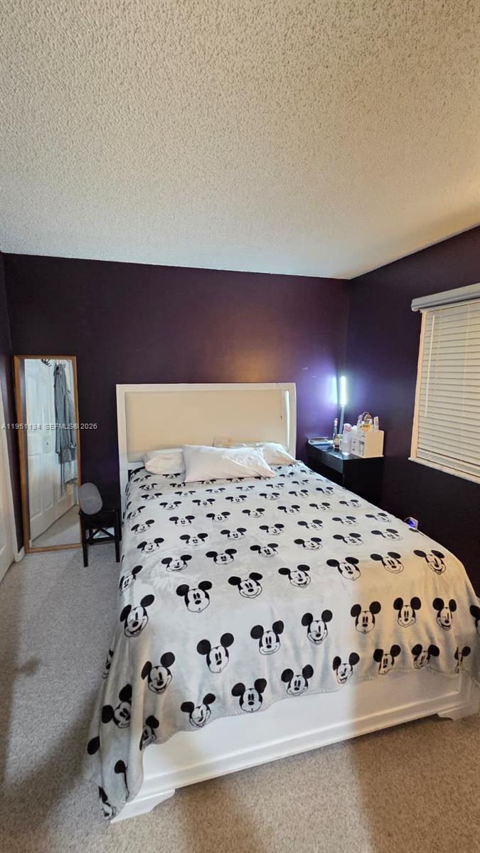 1308 Alexander Bend Weston, FL 33327 - Photo 22 of 54 a bedroom with a bed and a night stand