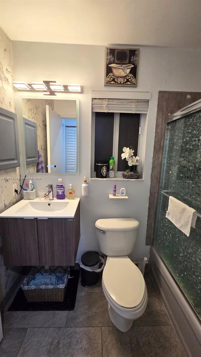 1308 Alexander Bend Weston, FL 33327 - Photo 27 of 54 a bathroom with a toilet sink and mirror