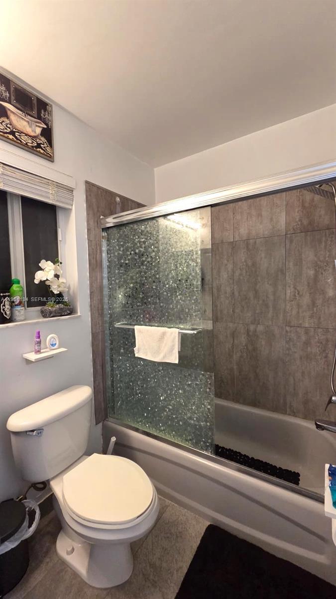 1308 Alexander Bend Weston, FL 33327 - Photo 28 of 54 a bathroom with a toilet a sink and a shower