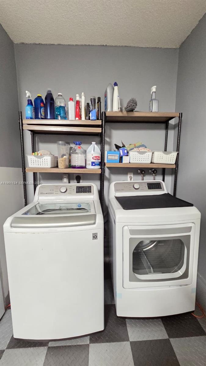 1308 Alexander Bend Weston, FL 33327 - Photo 30 of 54 a utility room with dryer and washer