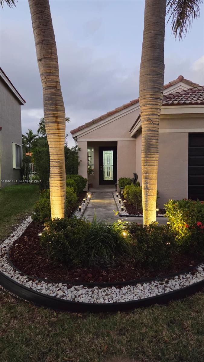 1308 Alexander Bend Weston, FL 33327 - Photo 33 of 54 a front view of a house with a yard