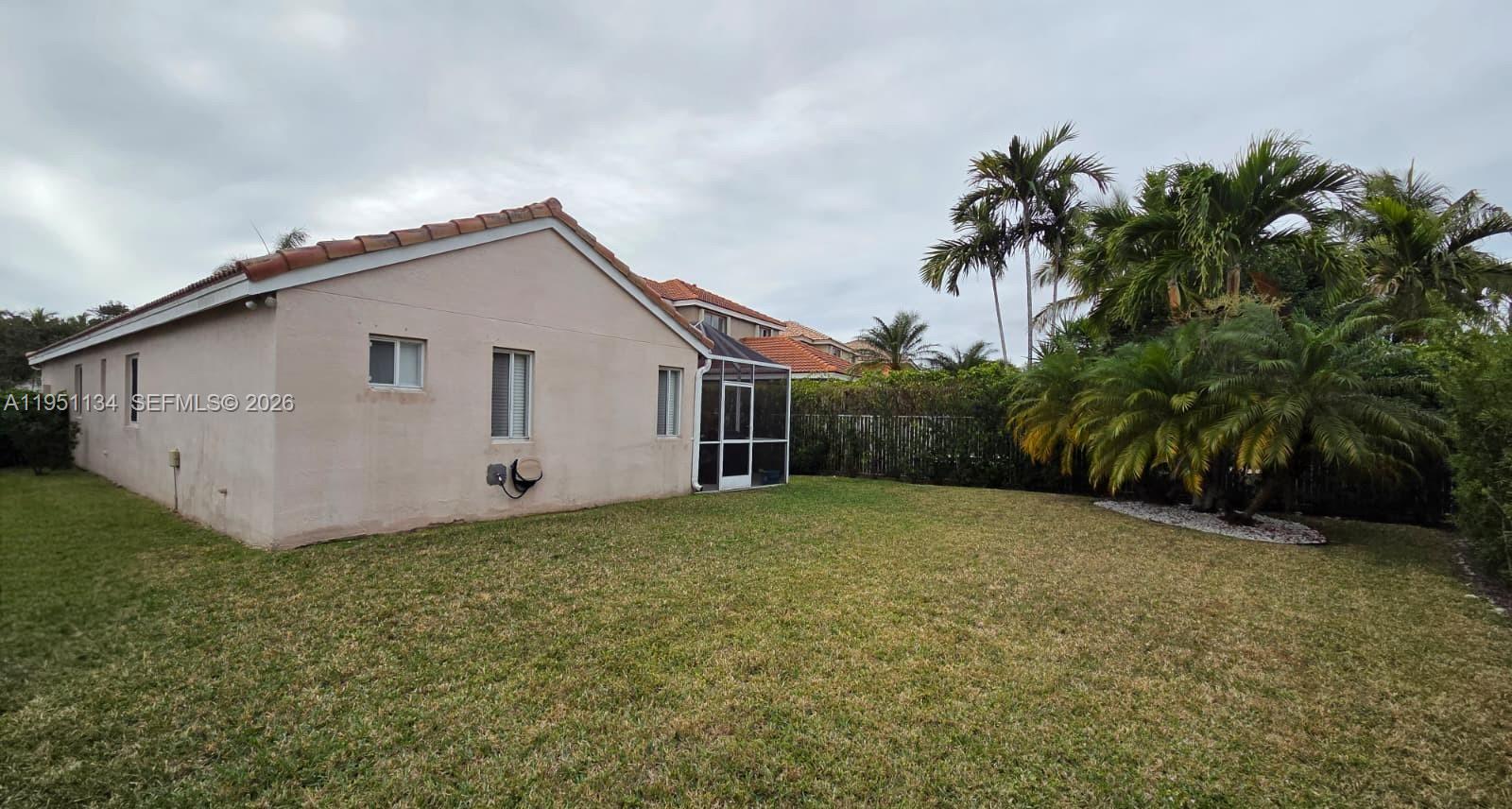 1308 Alexander Bend Weston, FL 33327 - Photo 36 of 54 a view of a house with a yard and a garage