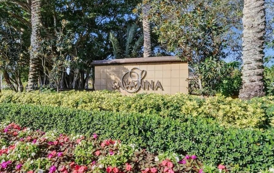 1308 Alexander Bend Weston, FL 33327 - Photo 44 of 54 a sign that is sitting in the middle of a bunch of flowers