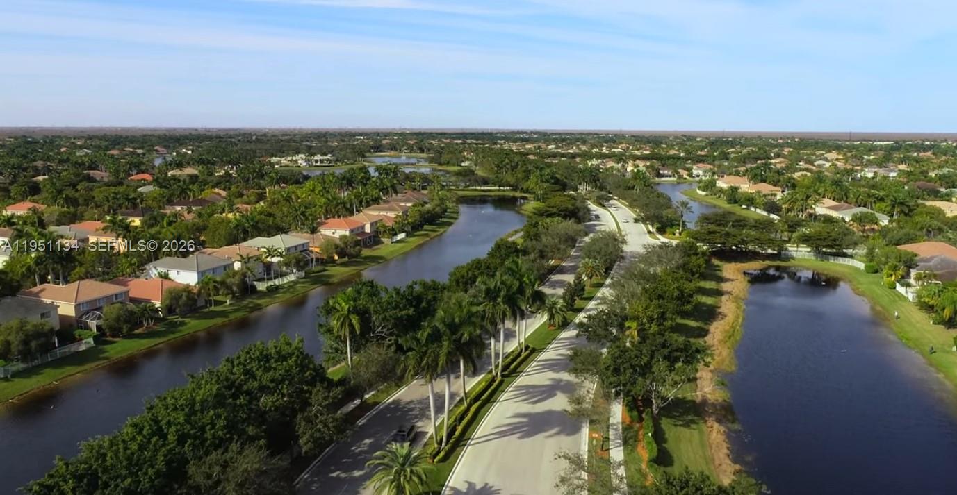 1308 Alexander Bend Weston, FL 33327 - Photo 46 of 54 an aerial view of residential houses with outdoor space and lake view