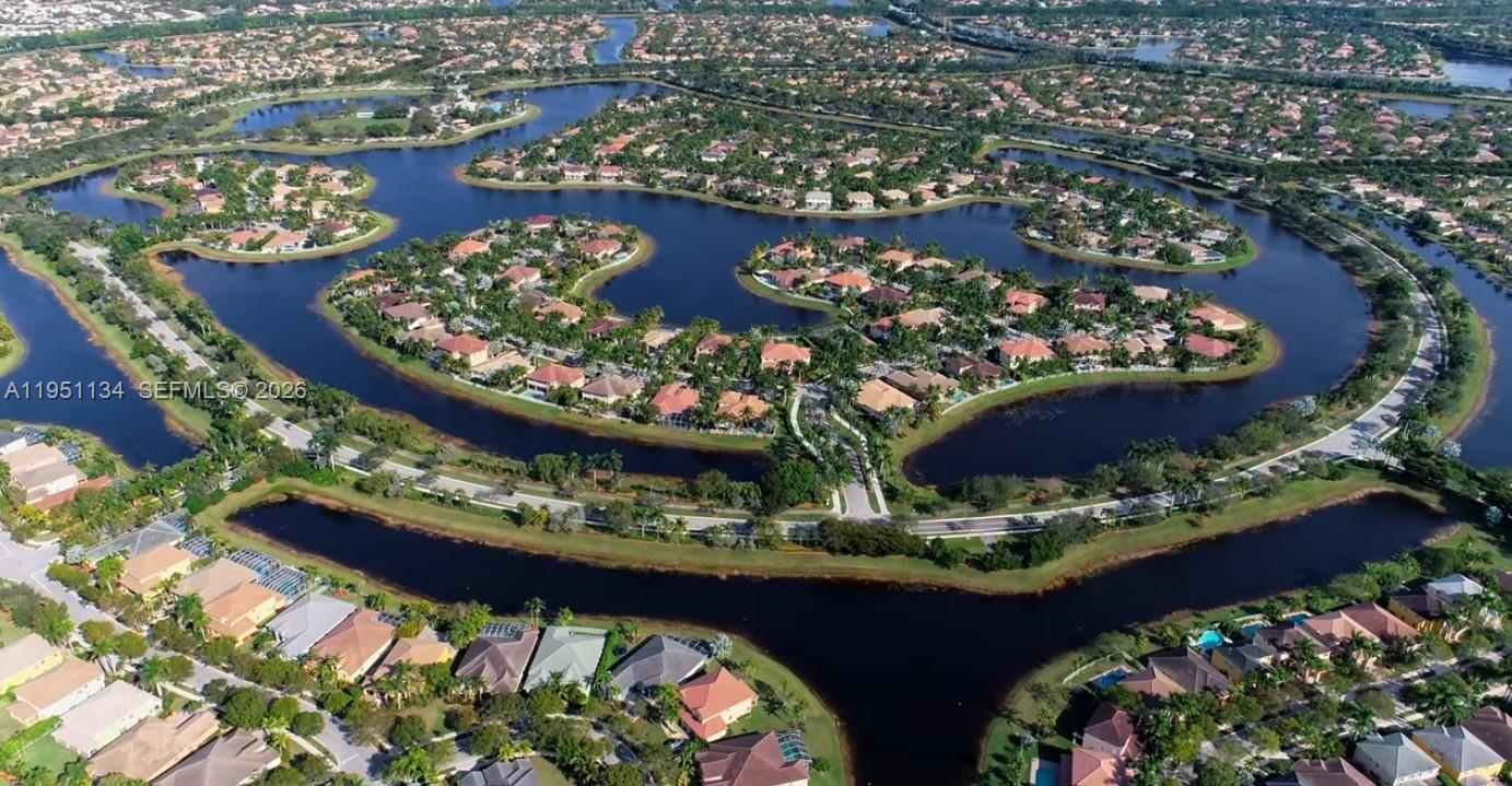 1308 Alexander Bend Weston, FL 33327 - Photo 50 of 54 an outdoor view of a dining room with a table and chairs