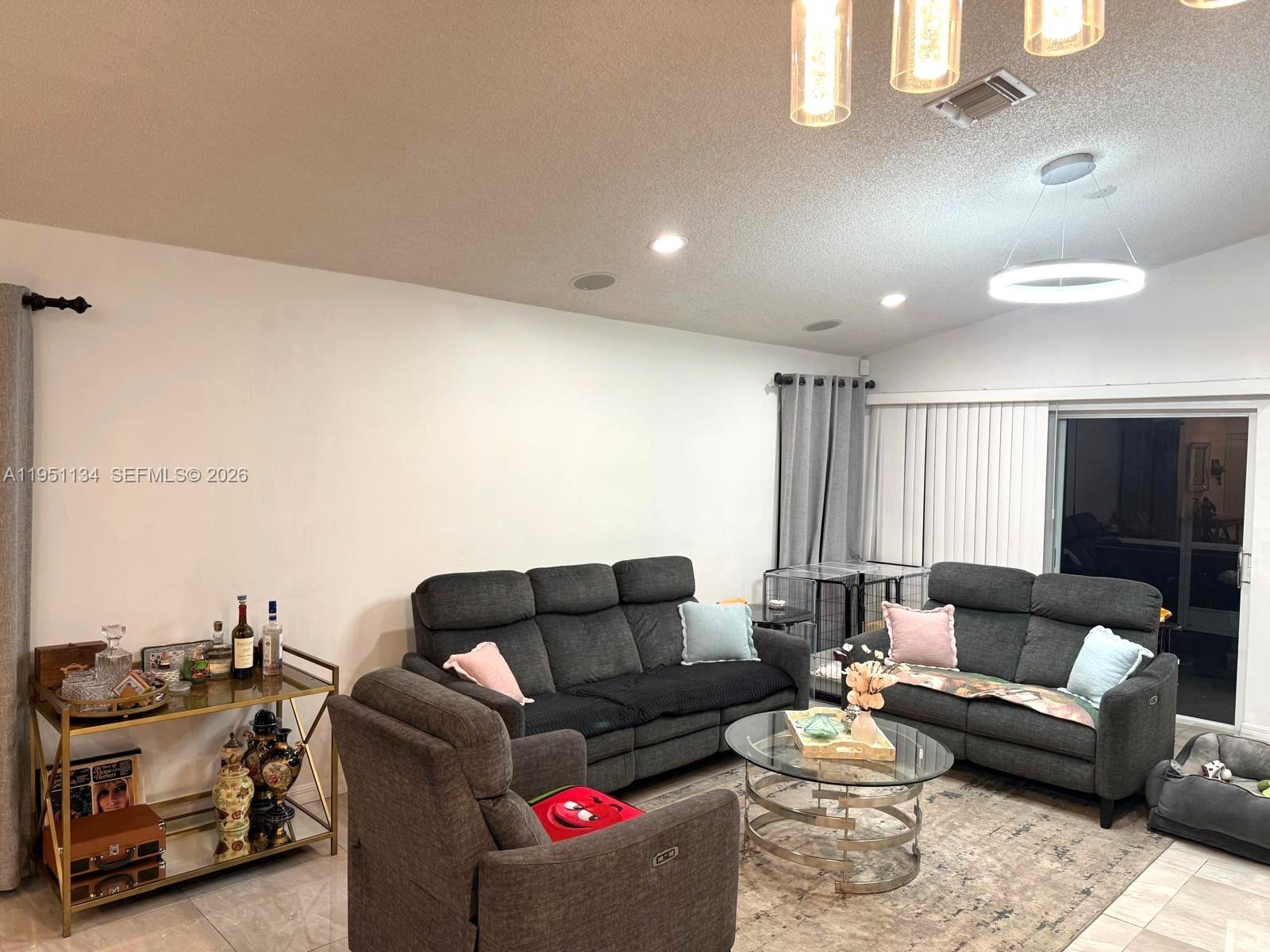 1308 Alexander Bend Weston, FL 33327 - Photo 10 of 54 a living room with furniture and a couch