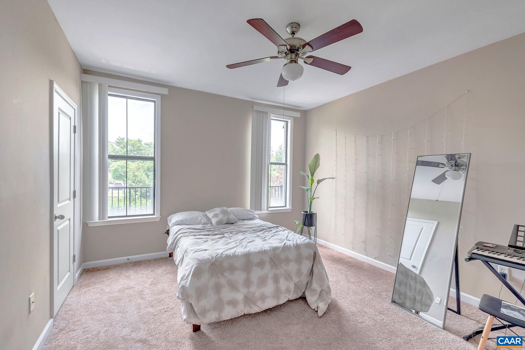745 Walker Square, Unit 3C Charlottesville, VA 22903 - Photo 5 of 10 a spacious bedroom with a bed and a window