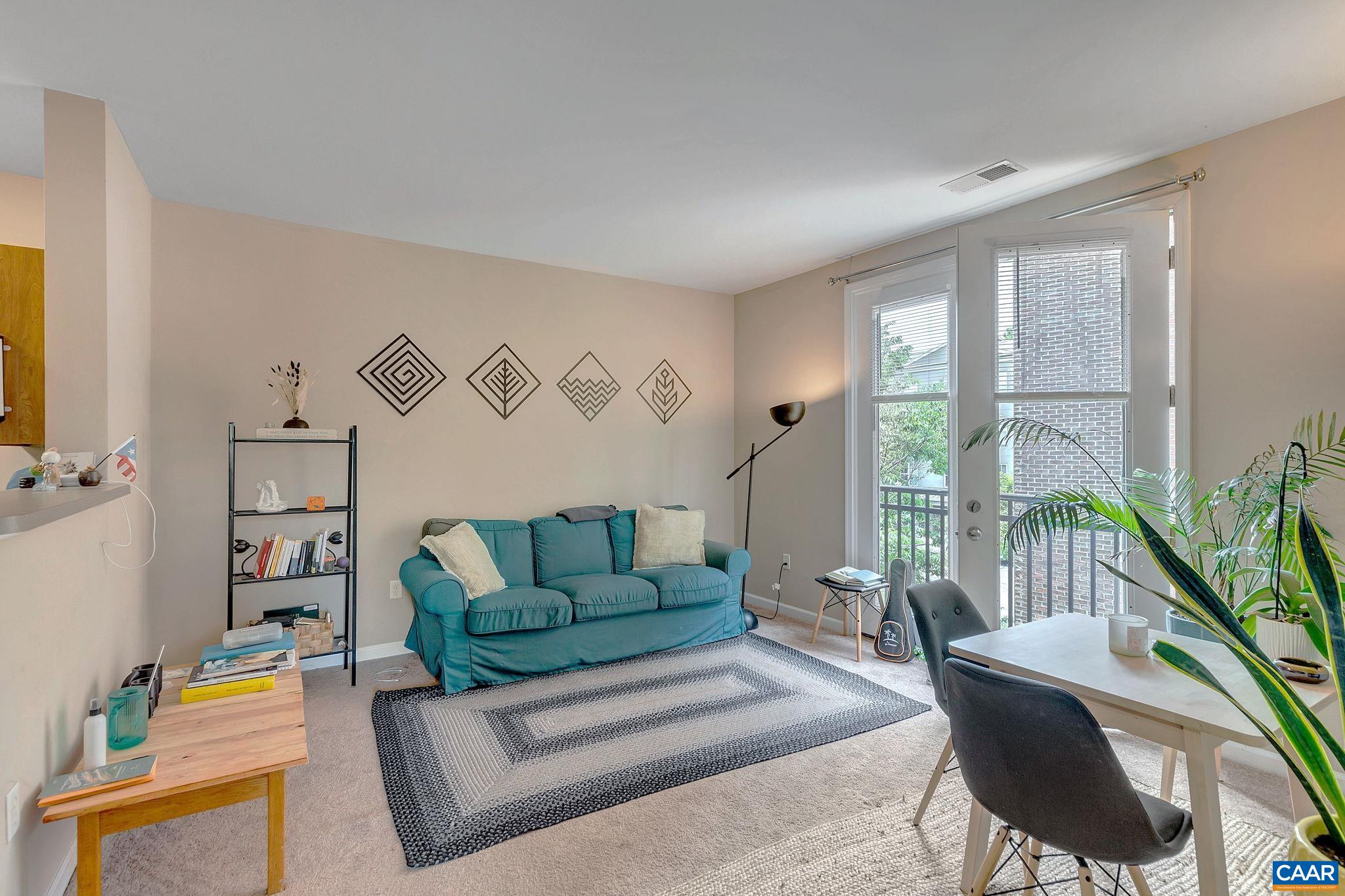 745 Walker Square, Unit 3C Charlottesville, VA 22903 - Photo 8 of 10 a living room with furniture and a potted plant