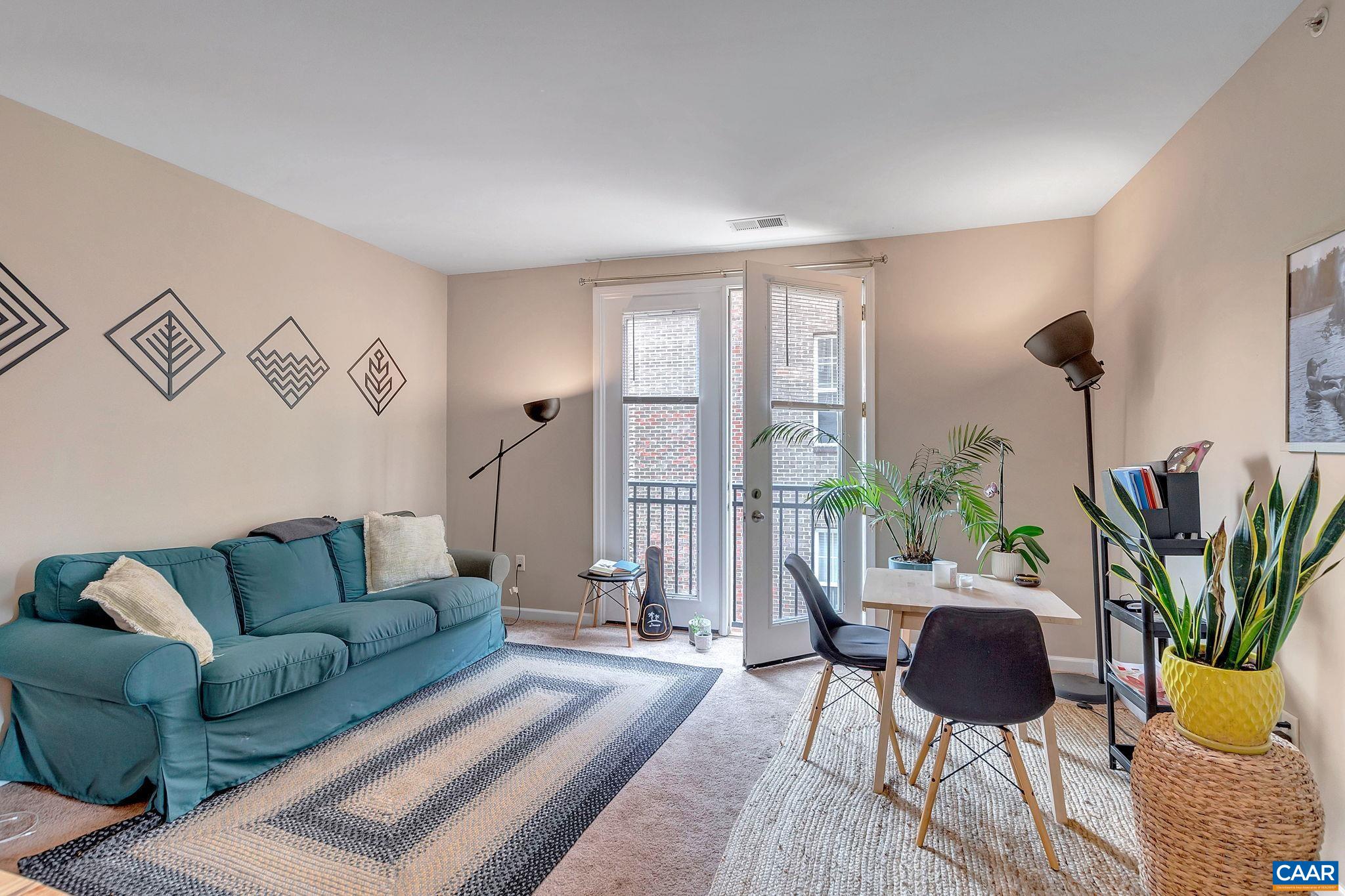 745 Walker Square, Unit 3C Charlottesville, VA 22903 - Photo 9 of 10 a living room with furniture and a potted plant
