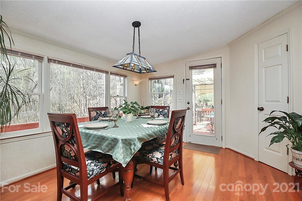 29032 Snapper Point Tega Cay, SC 29708 - Photo 16 of 48 a view of a dining room and livingroom with furniture wooden floor a chandelier