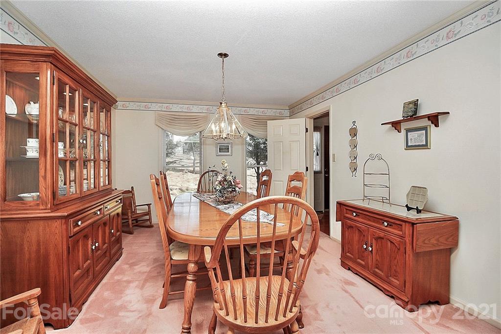 29032 Snapper Point Tega Cay, SC 29708 - Photo 19 of 48 a view of a dining room with furniture window and wooden floor
