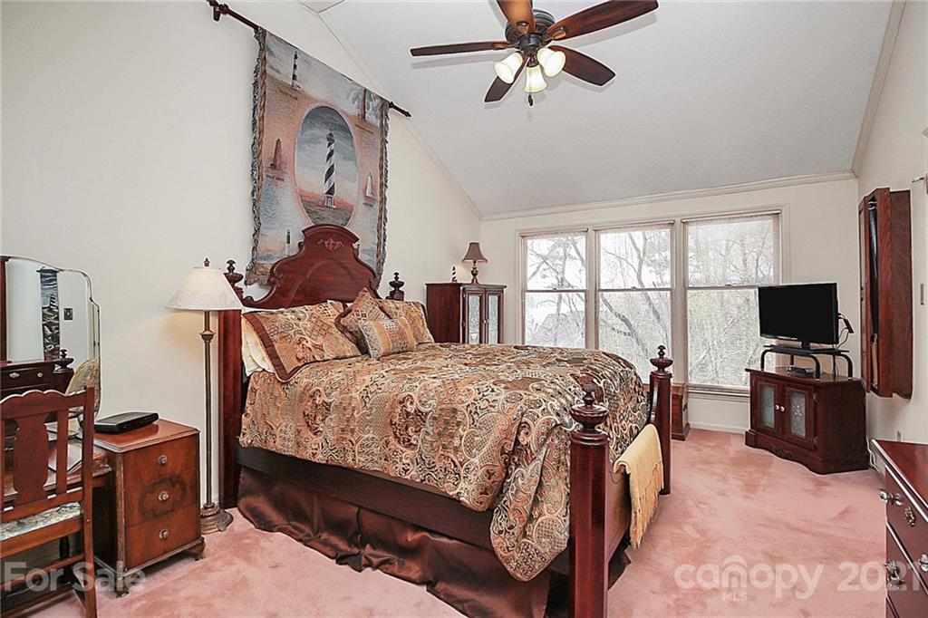 29032 Snapper Point Tega Cay, SC 29708 - Photo 22 of 48 a bedroom with a bed and a flat tv screen on the dresser