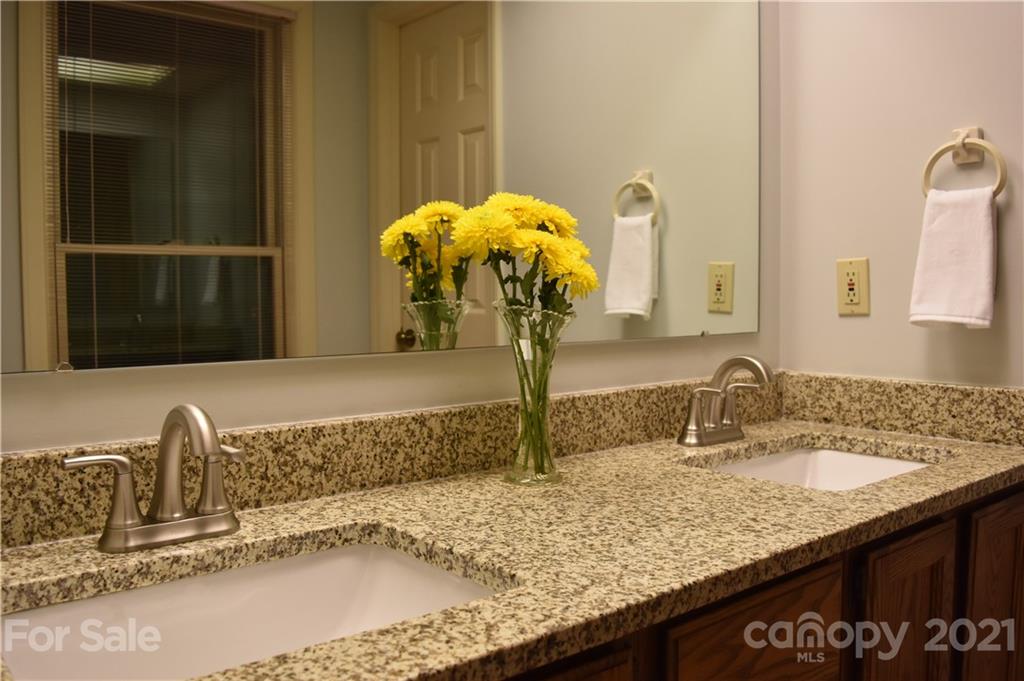 29032 Snapper Point Tega Cay, SC 29708 - Photo 23 of 48 a bathroom with a granite countertop sink and a mirror