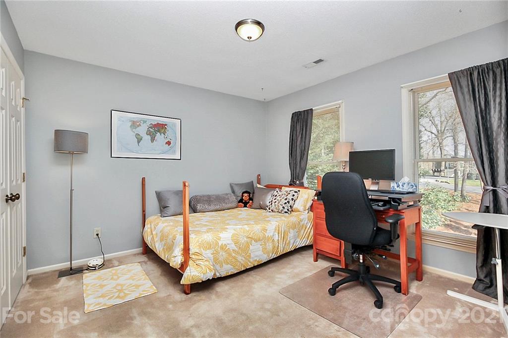 29032 Snapper Point Tega Cay, SC 29708 - Photo 25 of 48 a bedroom with a bed and a window
