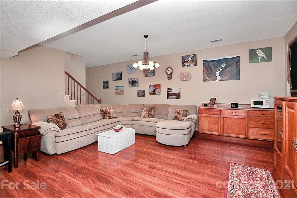 29032 Snapper Point Tega Cay, SC 29708 - Photo 27 of 48 a living room with furniture and a chandelier