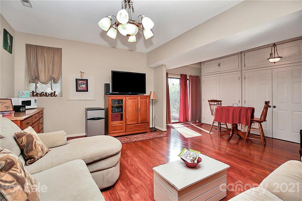 29032 Snapper Point Tega Cay, SC 29708 - Photo 28 of 48 a living room with furniture a flat screen tv and kitchen view