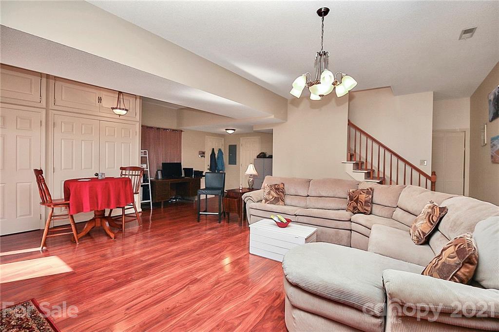 29032 Snapper Point Tega Cay, SC 29708 - Photo 29 of 48 a living room with furniture a dining table and a chandelier