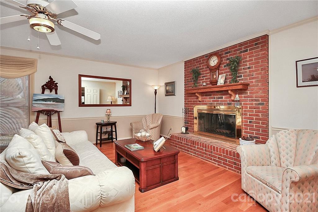 29032 Snapper Point Tega Cay, SC 29708 - Photo 6 of 48 a living room with furniture a fireplace and a flat screen tv