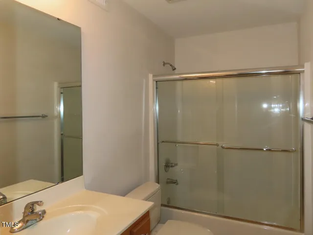 a bathroom with a shower and a toilet