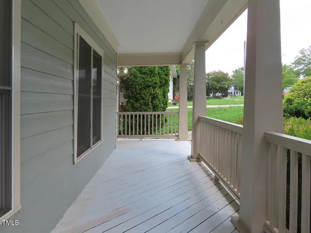 a view of a balcony with wooden floor
