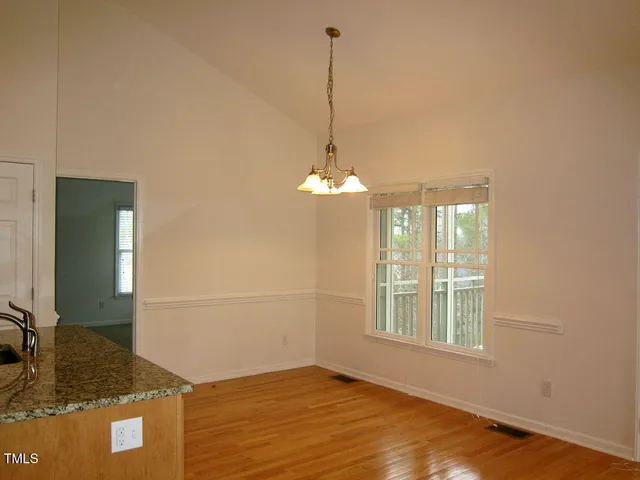 a view of a livingroom with a dishwasher cabinets and a wooden floor