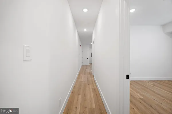 a view of a hallway with wooden floor