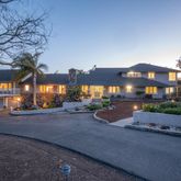 a front view of a house with yard and outdoor seating