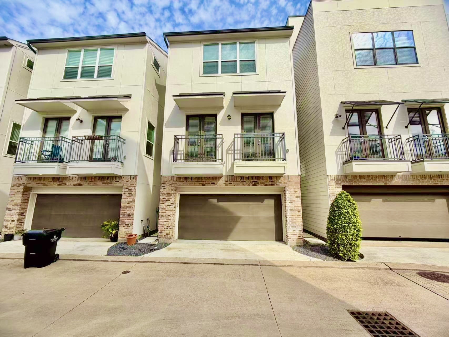 a front view of a house with a yard and a garage