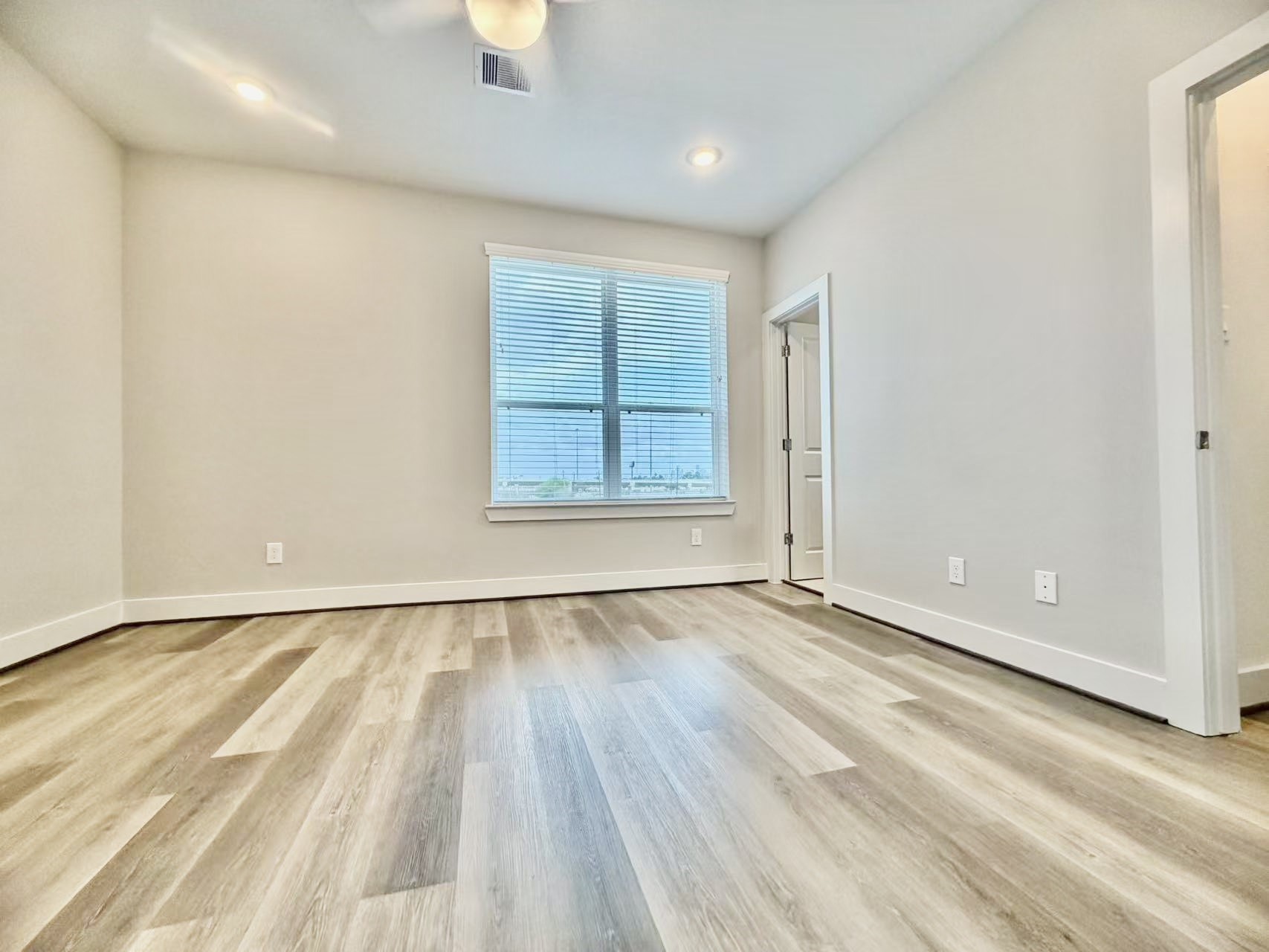 1254 North Post Oak Road, Unit B Houston, TX 77055 - Photo 15 of 25 an empty room with wooden floor and windows