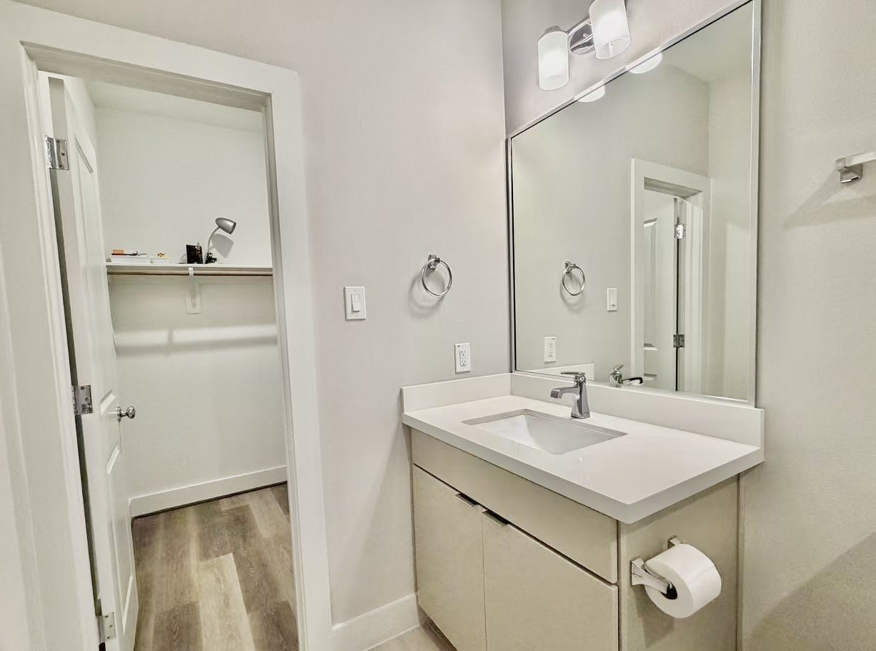 1254 North Post Oak Road, Unit B Houston, TX 77055 - Photo 4 of 25 a bathroom with a sink a mirror a vanity and a shower
