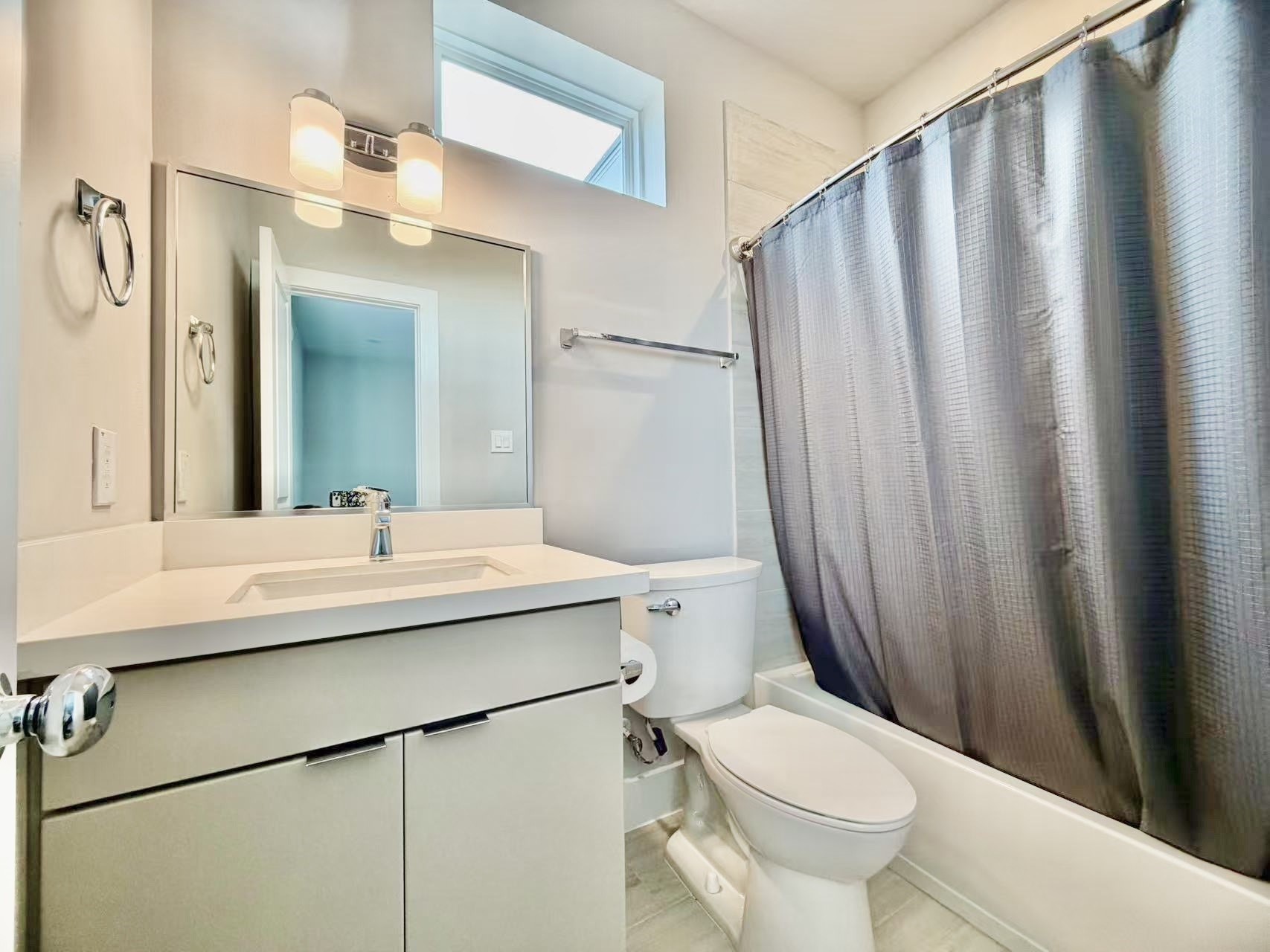 1254 North Post Oak Road, Unit B Houston, TX 77055 - Photo 5 of 25 a bathroom with a sink a toilet a mirror and shower curtain