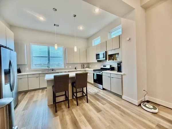 a kitchen with a sink appliances and cabinets