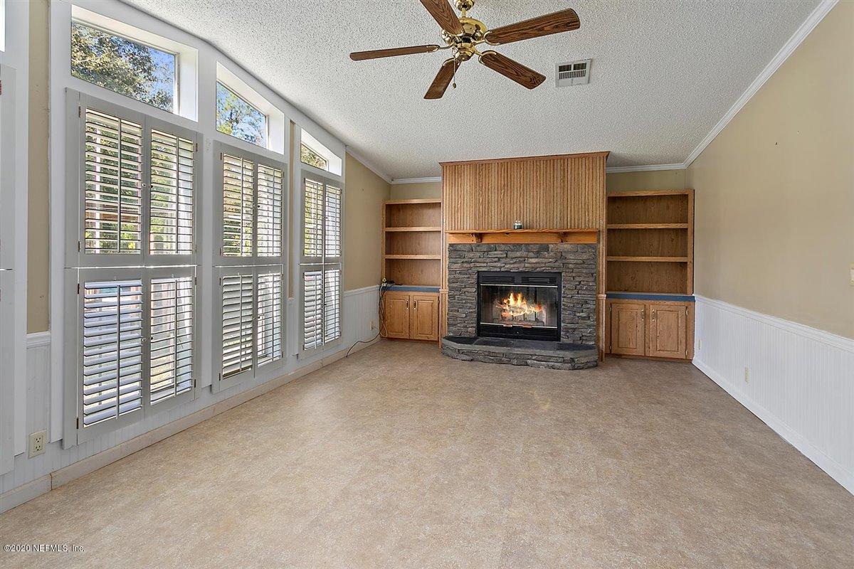 2987 Green Acres Road St. Augustine, FL 32084 - Photo 12 of 31 a view of an empty room with a fireplace and a window