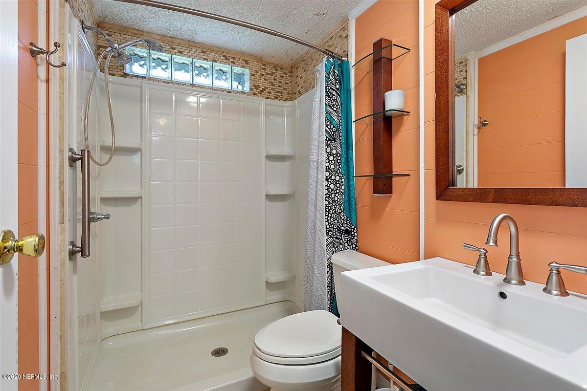 2987 Green Acres Road St. Augustine, FL 32084 - Photo 19 of 31 a bathroom with a sink toilet and shower