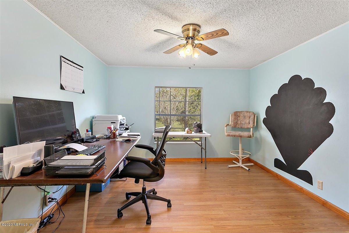 2987 Green Acres Road St. Augustine, FL 32084 - Photo 20 of 31 a view of a workspace with furniture and a window